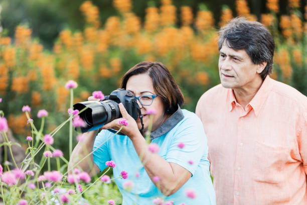 istock Senior Hispanic couple photographing nature 1203477299