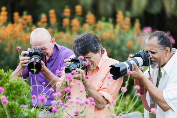istock Three men taking photos in garden 1203477620