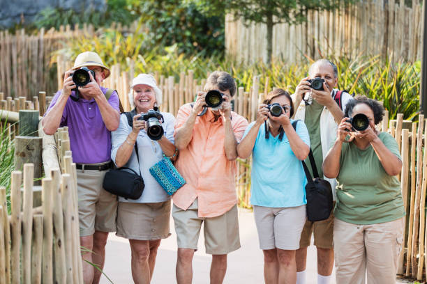 istock Group of seniors in park with cameras 1203478295