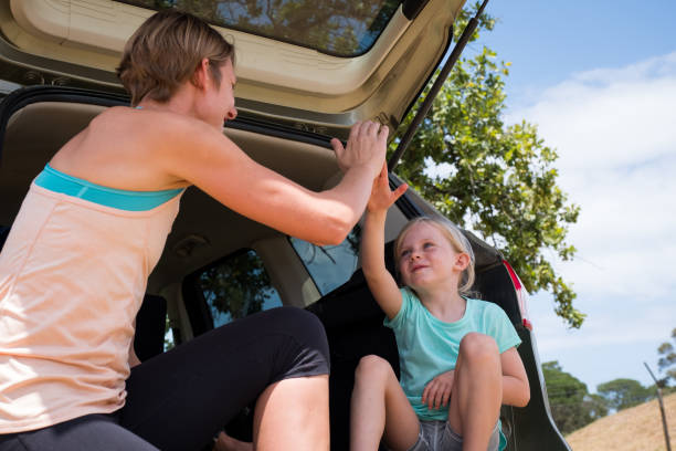 istock Mother and daughter high 5 each other 1203478319