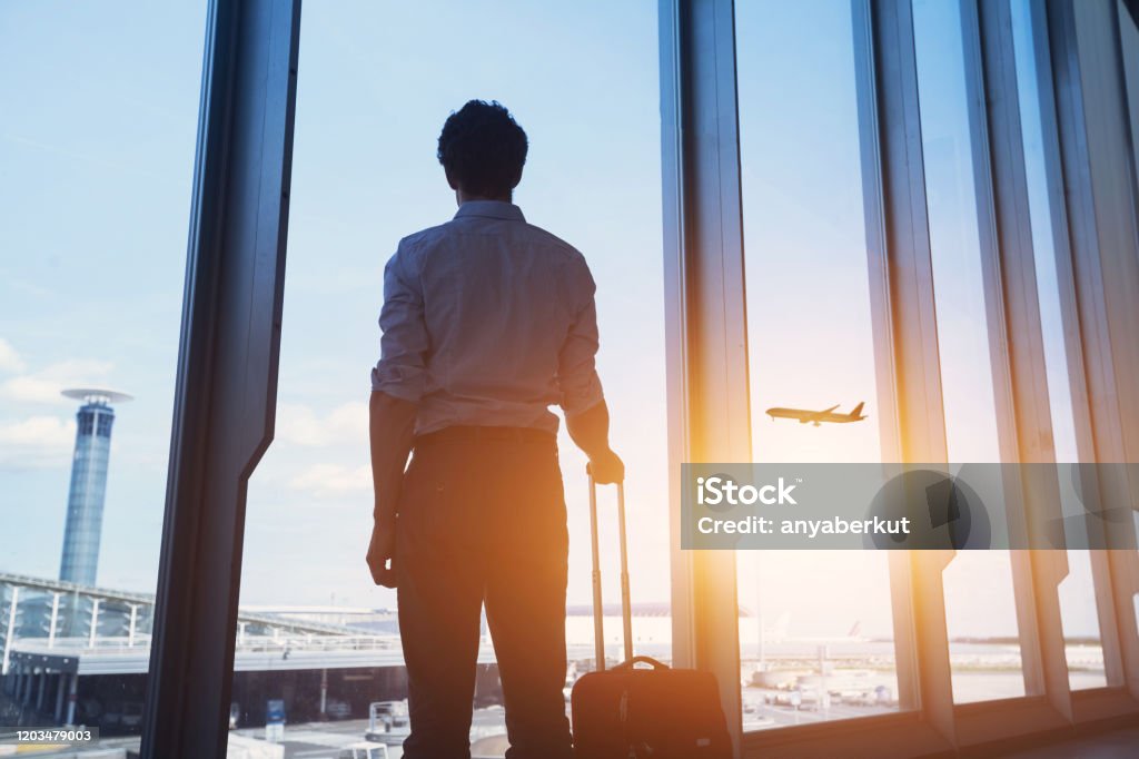 business travel, man in airport travel concept, business man silhouette in airport Airport Stock Photo