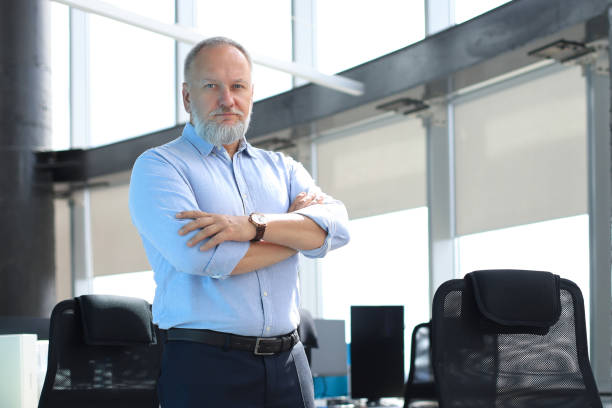 istock Confident pensive mature business man in modern office. 1203486868