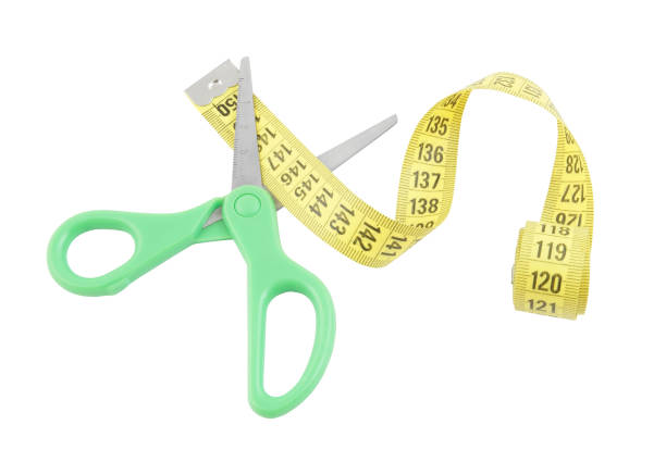 istock Modern green scissors and measuring tape isolated 1203495867