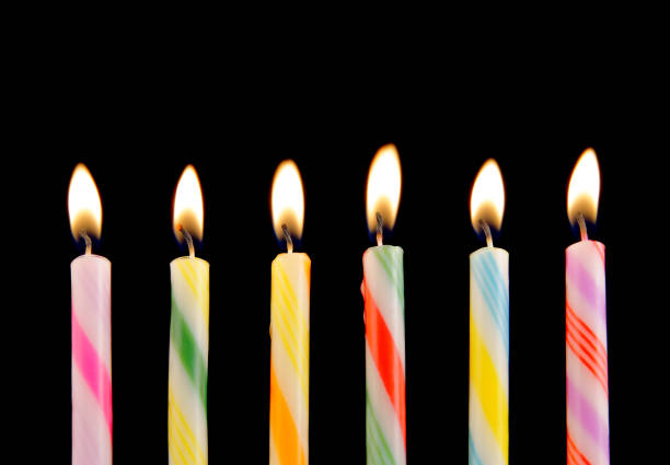 istock Colorful birthday candles on black background 1203498951