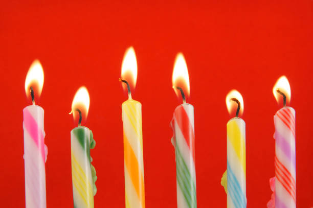 istock Colorful birthday candles on blue background 1203498962