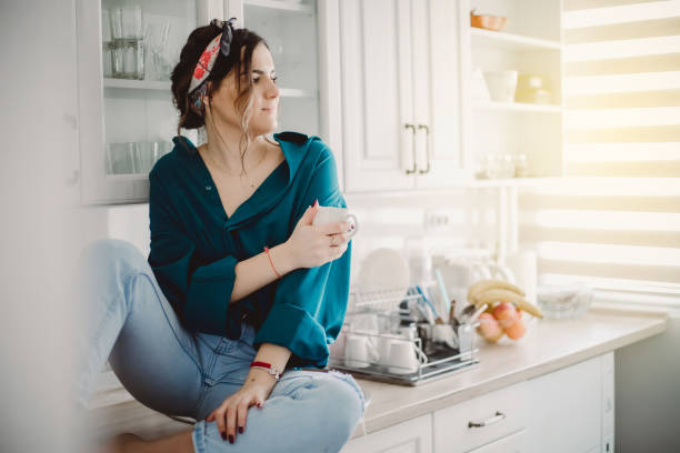 istock Young Woman drinking first morning coffee 1203498975