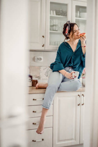 istock Young Woman drinking first morning coffee 1203499074