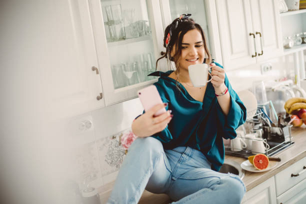 istock Young Woman drinking first morning coffee 1203499102
