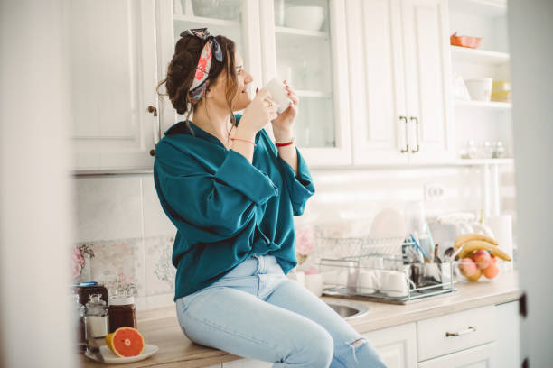istock Young Woman drinking first morning coffee 1203499141