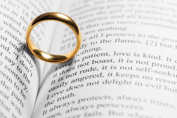 istock Golden wedding ring on bible book 1203499339