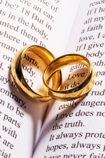 istock Golden wedding rings on bible book 1203499341