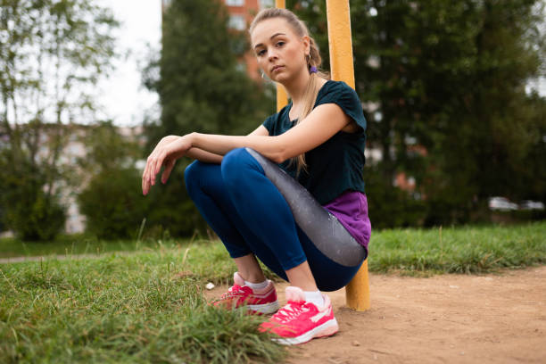 istock Beautiful athletic girl showing a class sign. 1203501208