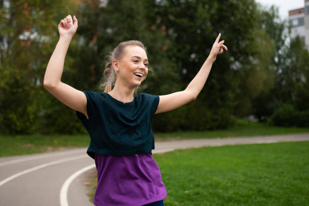 istock Athletic girl, on a treadmill, having fun and smiling. 1203502024