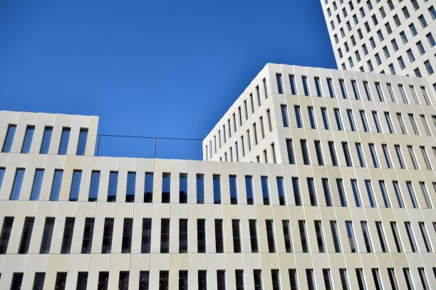 istock Modern office building detail. Perspective view of geometric angular concrete windows on the facade of a modernist brutalist style building. 1203503600