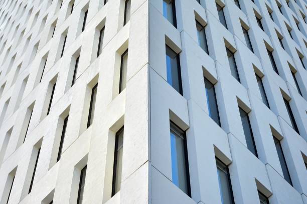 istock Modern office building detail. Perspective view of geometric angular concrete windows on the facade of a modernist brutalist style building. 1203503612