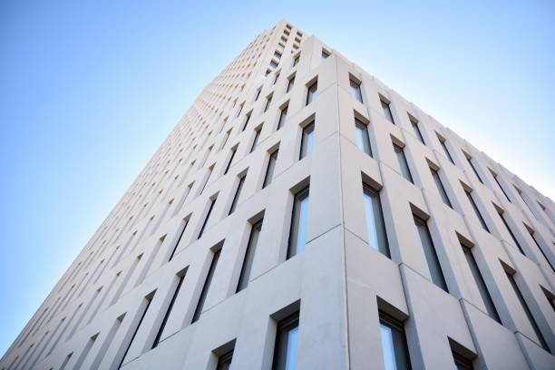 istock Modern office building detail. Perspective view of geometric angular concrete windows on the facade of a modernist brutalist style building. 1203504186
