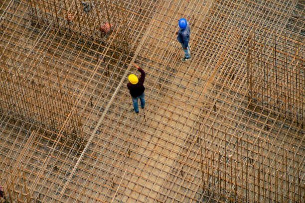 istock Construction workers in India standing on a rebar reinforcing bar platform making a pillar 1203504385