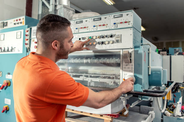 istock Workers in a printing factory 1203507899