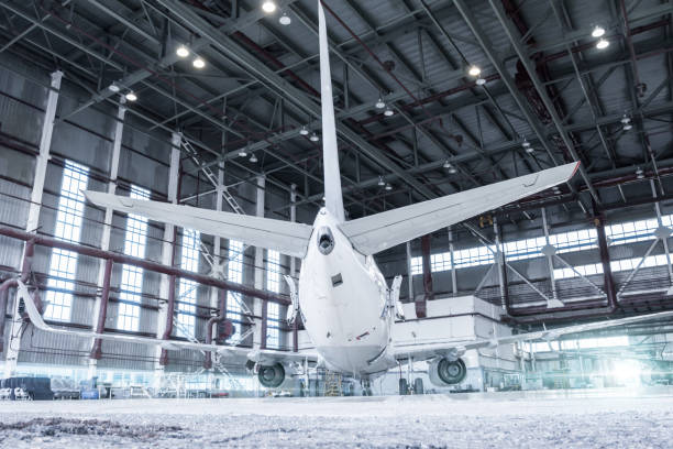 istock White passenger airplane in the hangar under maintenance. Checking mechanical systems for flight operations 1203508020