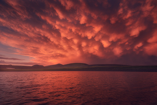Beautiful red clouds over the lake after rain, Georgia, Caucasus mountains