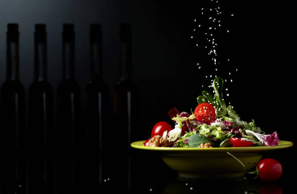 istock Green salad with cherry tomatoes,  sesame, walnuts and vegetable oil. 1203509177