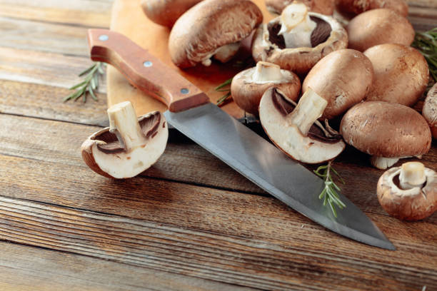 istock Fresh mushrooms mushroom on an old wooden table. 1203509196