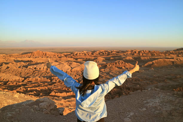 Female Hiker Excited with the Moon Valley or Valle de la Luna in Atacama Desert, Northern Chile Female Hiker Excited with the Moon Valley or Valle de la Luna in Atacama Desert, Northern Chile, (Self Portrait) atacama desert photos stock pictures, royalty-free photos & images