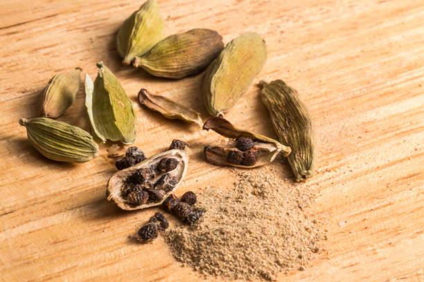 Green cardamom pods, seeds and ground spice Green cardamom pods, seeds and ground spice. Close-up on natural wooden background cardamom stock pictures, royalty-free photos & images