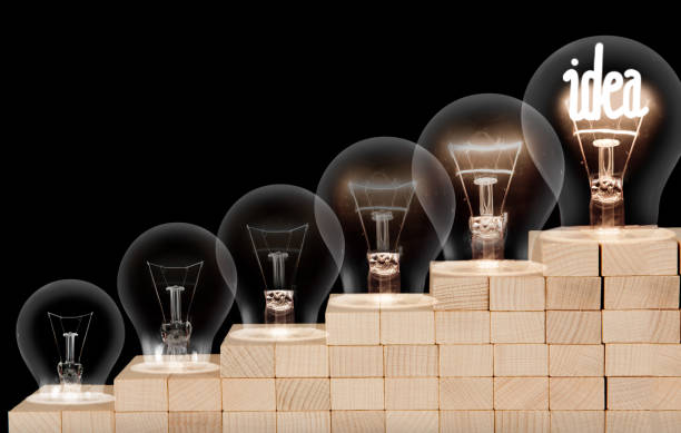 istock Dark and Shining Light Bulbs with Idea Concept 1203510434