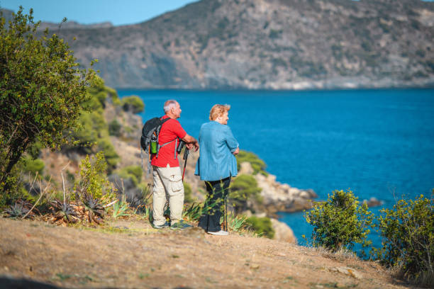 istock Active Senior Couple Resting on Mediterranean Coastal Trail 1203511178