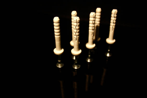 istock Six wall dowel pin with screw isolated on black with reflections 1203511328