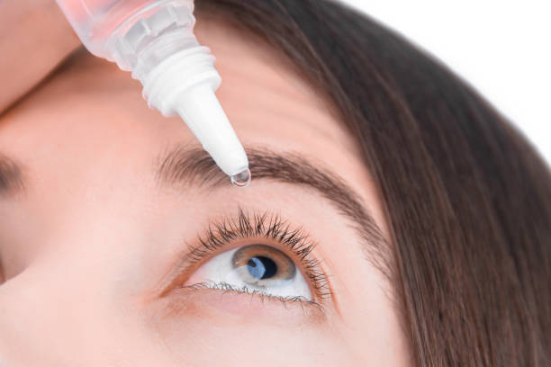 Young woman face with drops for eyes Closeup female hand is holding little bottle with healing drops. Young woman is going to drip medication, artificial tear into eye. Treatment and prevention ophthalmic diseases concept. eyedropper stock pictures, royalty-free photos & images