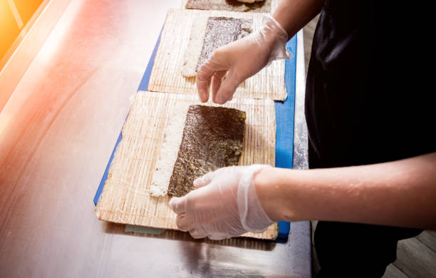 istock Process of making sushi and rolls at restaurant kitchen. 1203513808