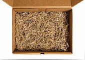Brown shredded paper for gifting and stuffing in cardboard box.