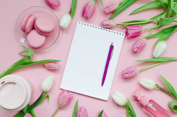 istock Notepad wish list for future plans. flat lay composition with flowers, a notepad, cup of coffee and sweets 1203515627