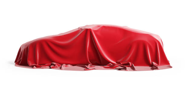 istock Car covered with red silk cloth. Isolated on a white background with clipping path. 1203516692