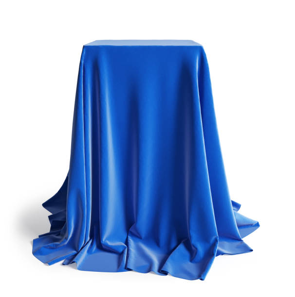 istock Empty podium covered with blue silk cloth. Isolated on a white background with clipping path. 1203516710