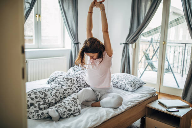 istock Young woman is stretching after waking up 1203519006