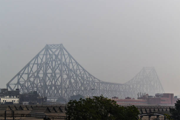Howrah bridge is covered by fog Howrah bridge is covered by fog and also smog for polluted air in Kolkata, India. kolkata stock pictures, royalty-free photos & images