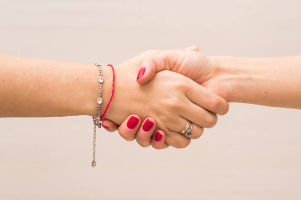 Handshake of two women. Struggle for equal rights, agreement.