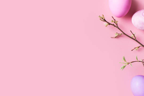 istock Easter pink flat lay with colorful eggs and branch with leaves 1203521366