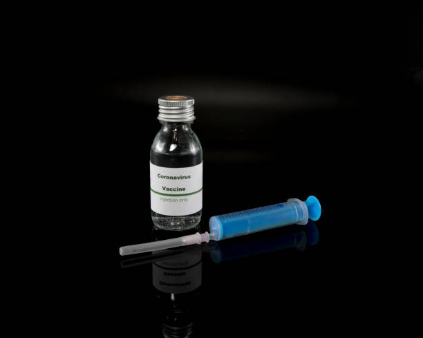 istock Coronavirus vaccine vial with injection syringe 1203522661