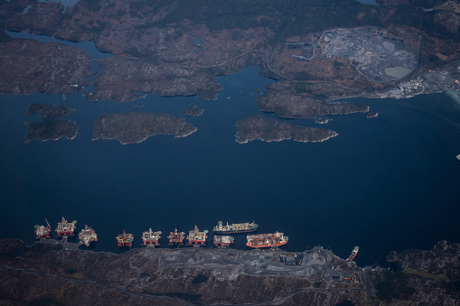 Passenger view from an airplane over an industrial sea area in Norway