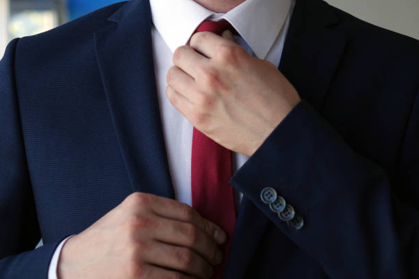 istock businessman correcting a tie close up 1203526327