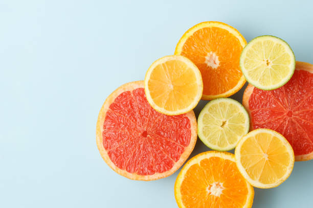 istock Colorful sliced fruits on blue background with copy space 1203530022