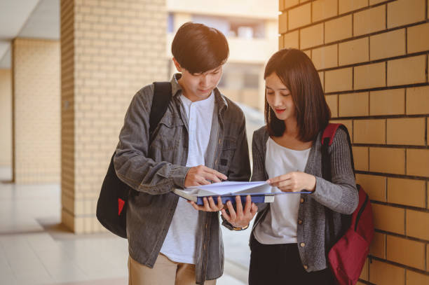 istock Education, Learning, Student, Campus, University, Lifestyle concept. Two students are discussing about exam preparation, presentation, study, study for test preparation in University. 1203530490