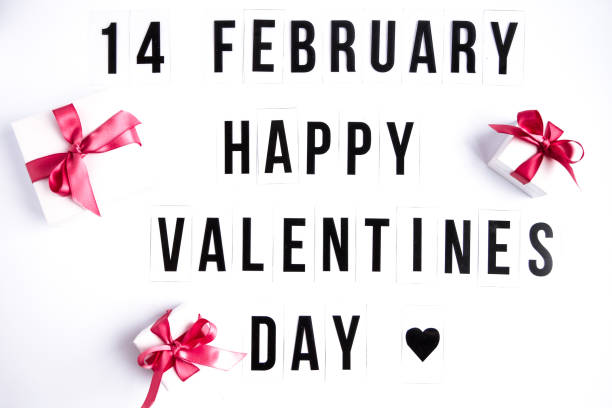 istock 14 february, Happy valentines day text on white table background, with gift boxes 1203534029