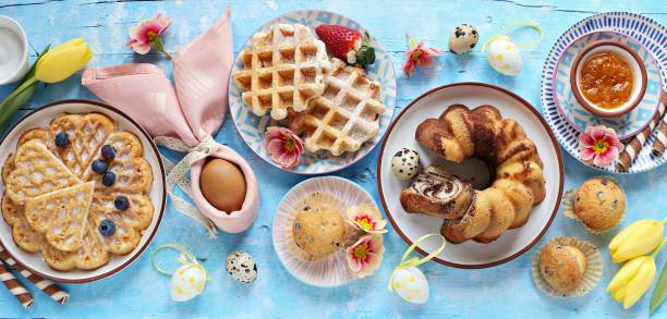 istock Easter festive dessert table with various of cakes, waffles and sweets. 1203535282