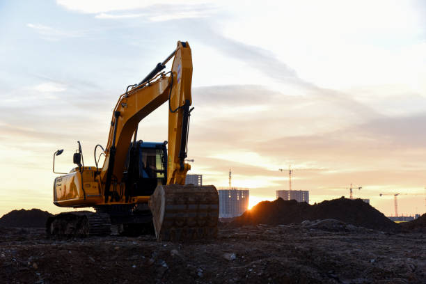 istock Large tracked excavator at a construction site on the background sunset 1203535300