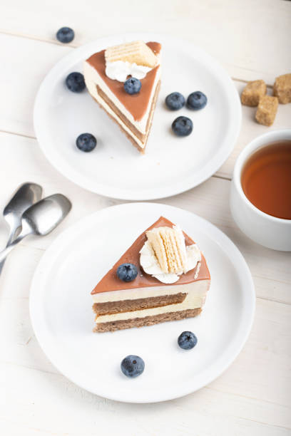 istock slice of cake with cream in a plate on the table. 1203539796